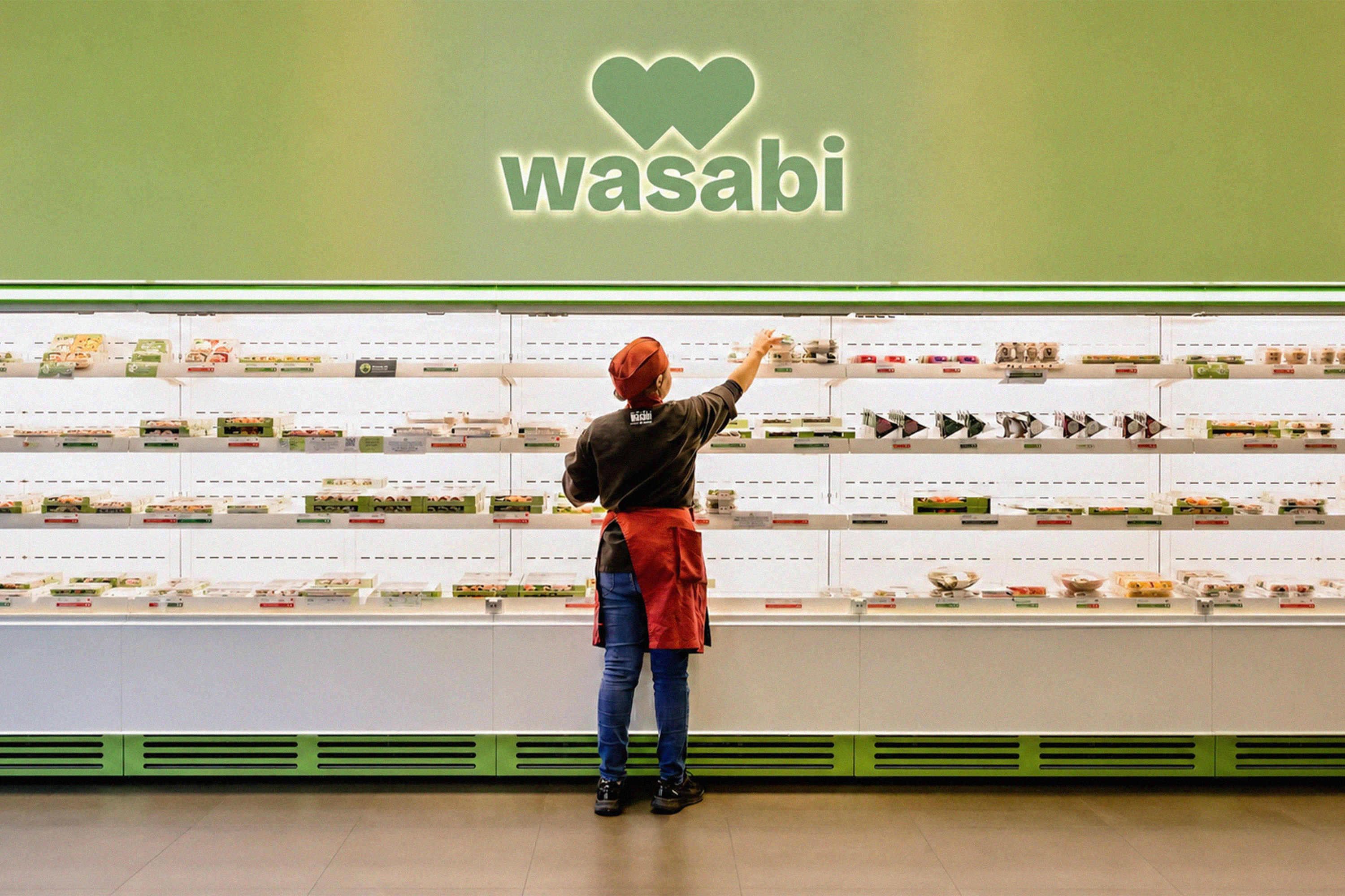 Wasabi store interior with a green wordmark above the food display.