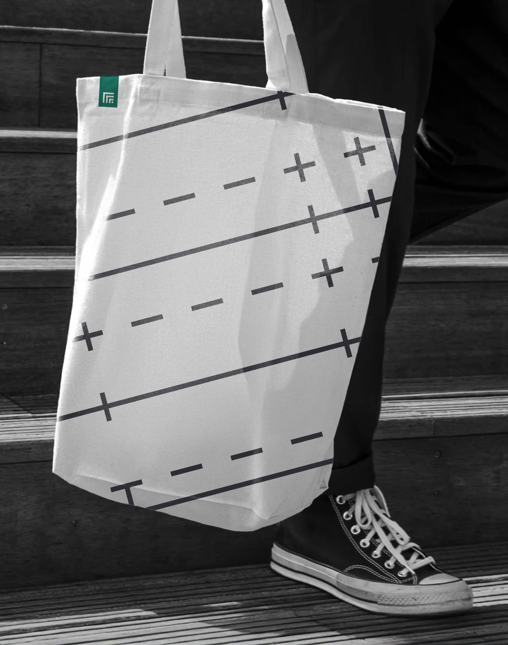 A white Foulston Park tote bag patterned with green symbols.