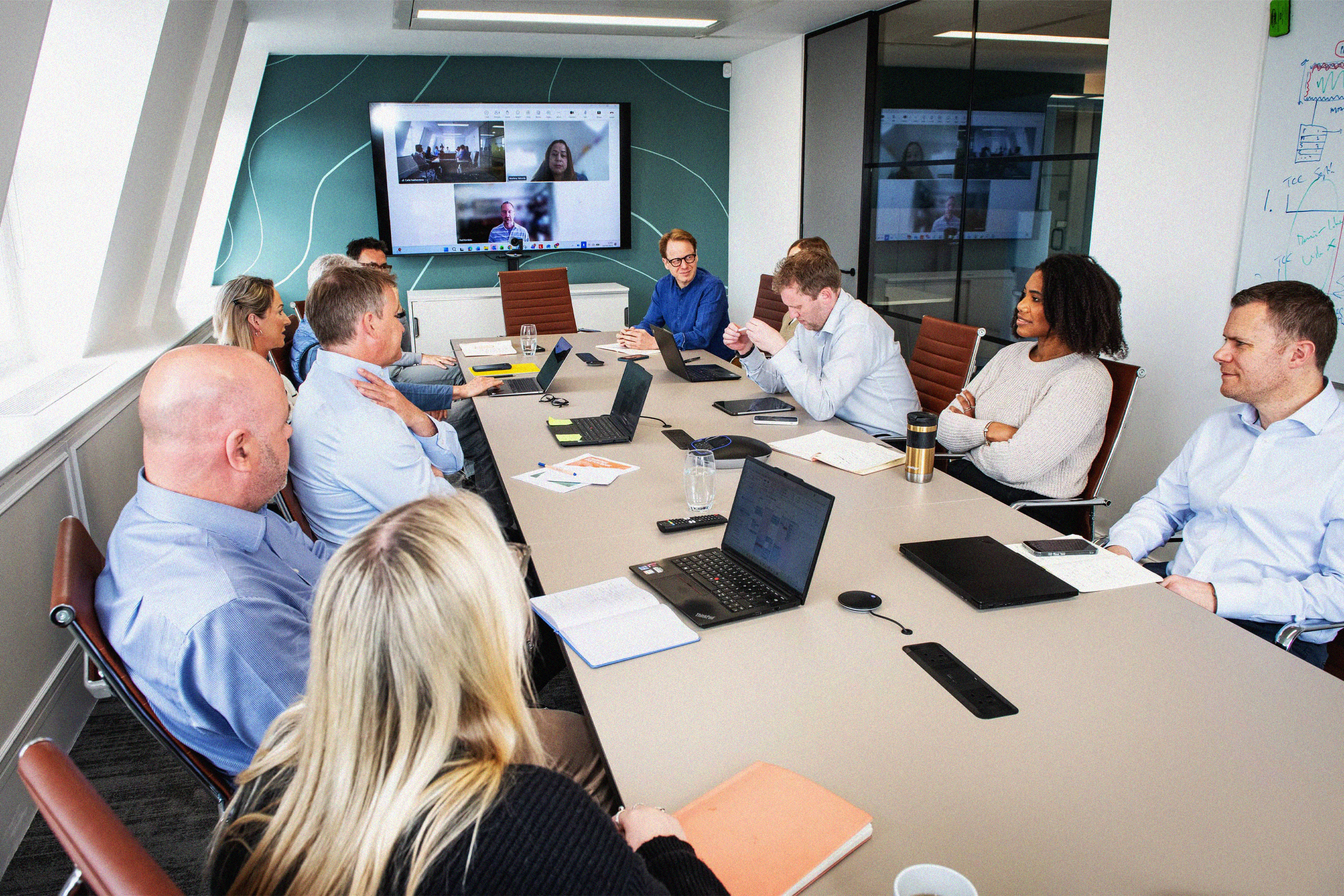 The GummerLeathes team in a meeting around a conference table.