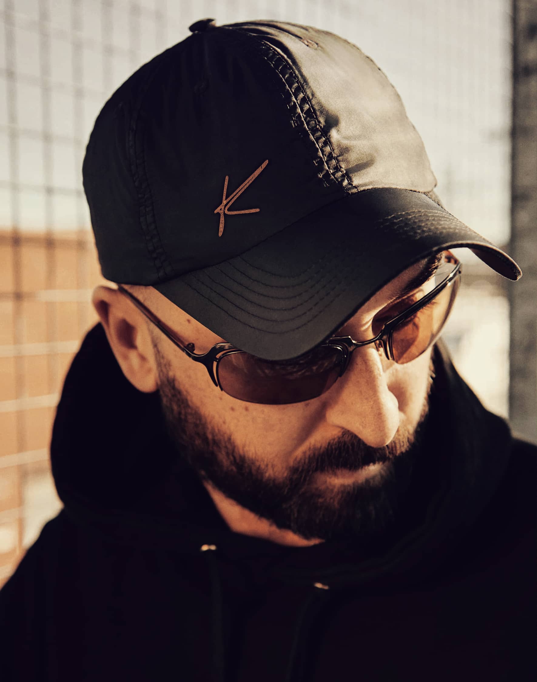 A black cap embroidered with the Experiences by Katie monogram.