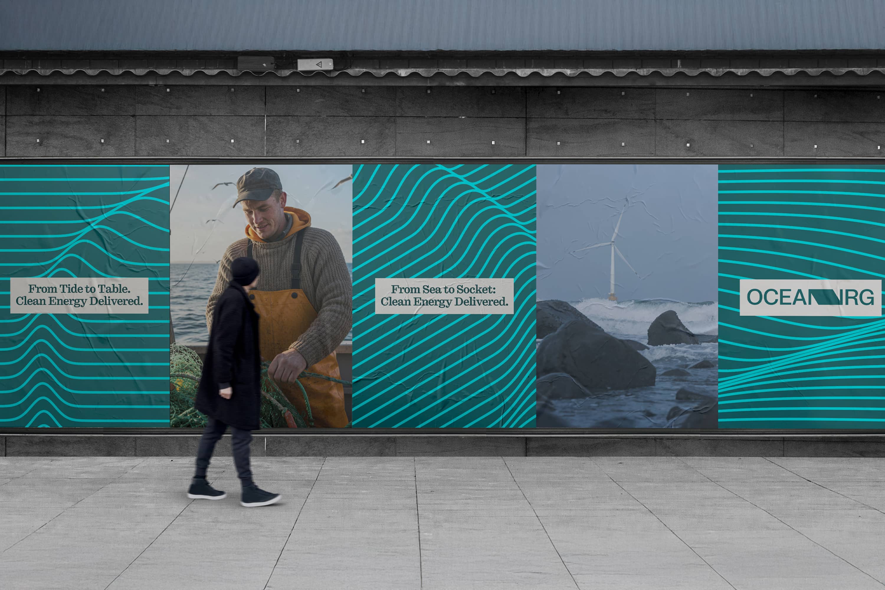 Ocean NRG posters with turquoise wave graphics on a street wall.