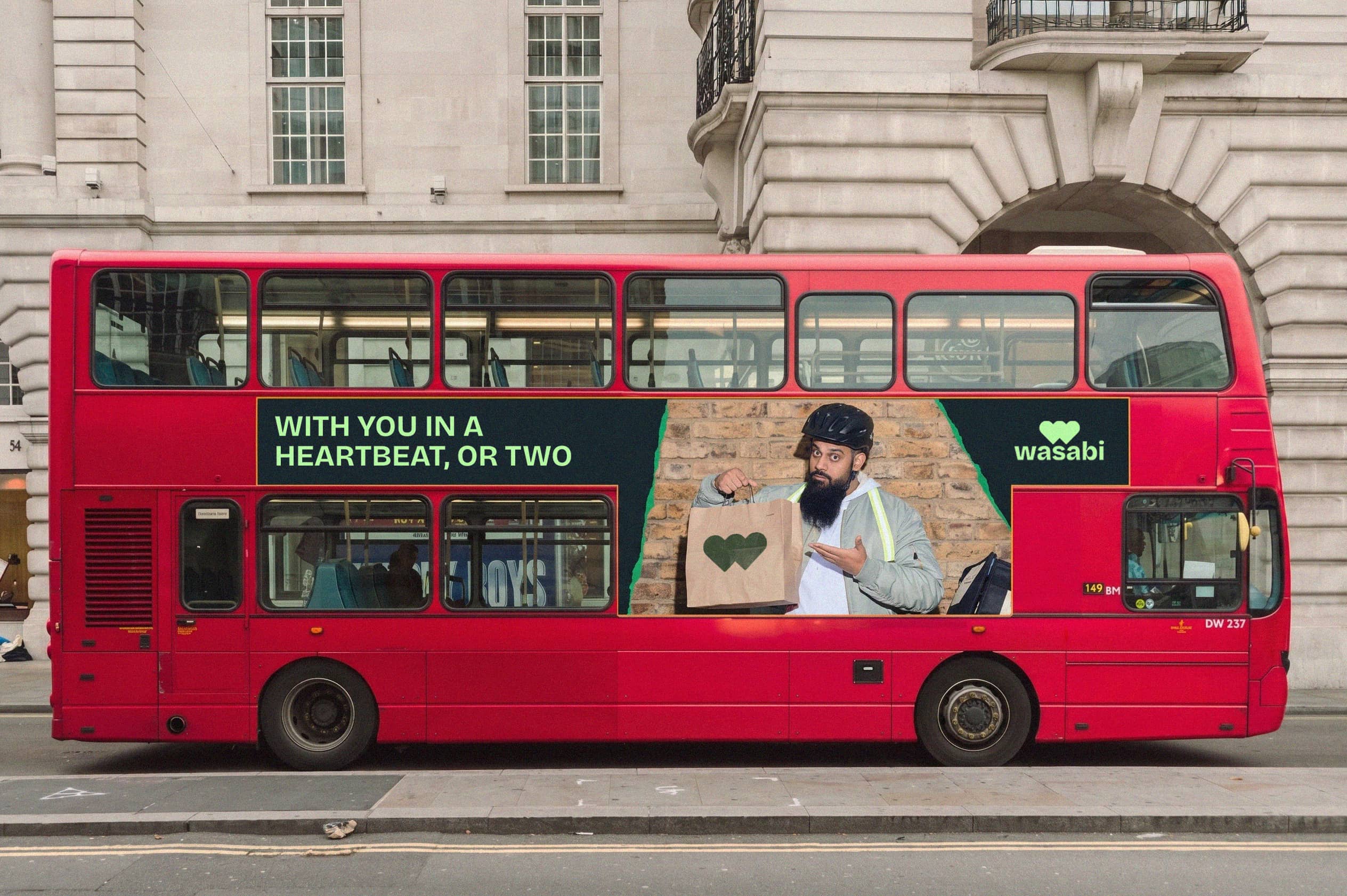 A red London bus carrying a Wasabi advertisement.