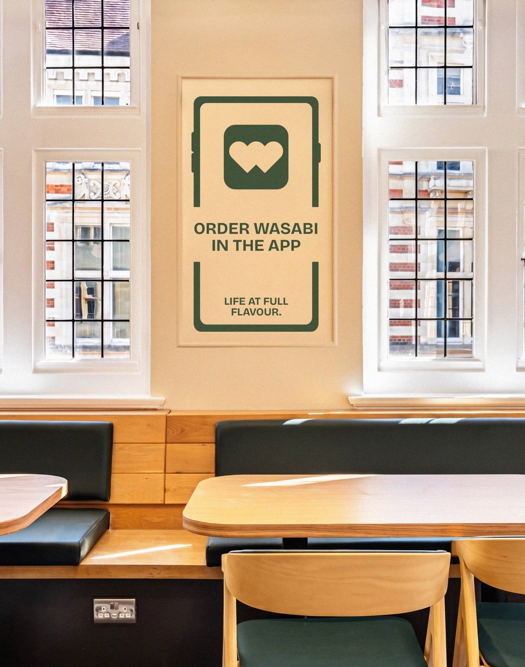 A Wasabi restaurant seating area with green and cream brand graphics.