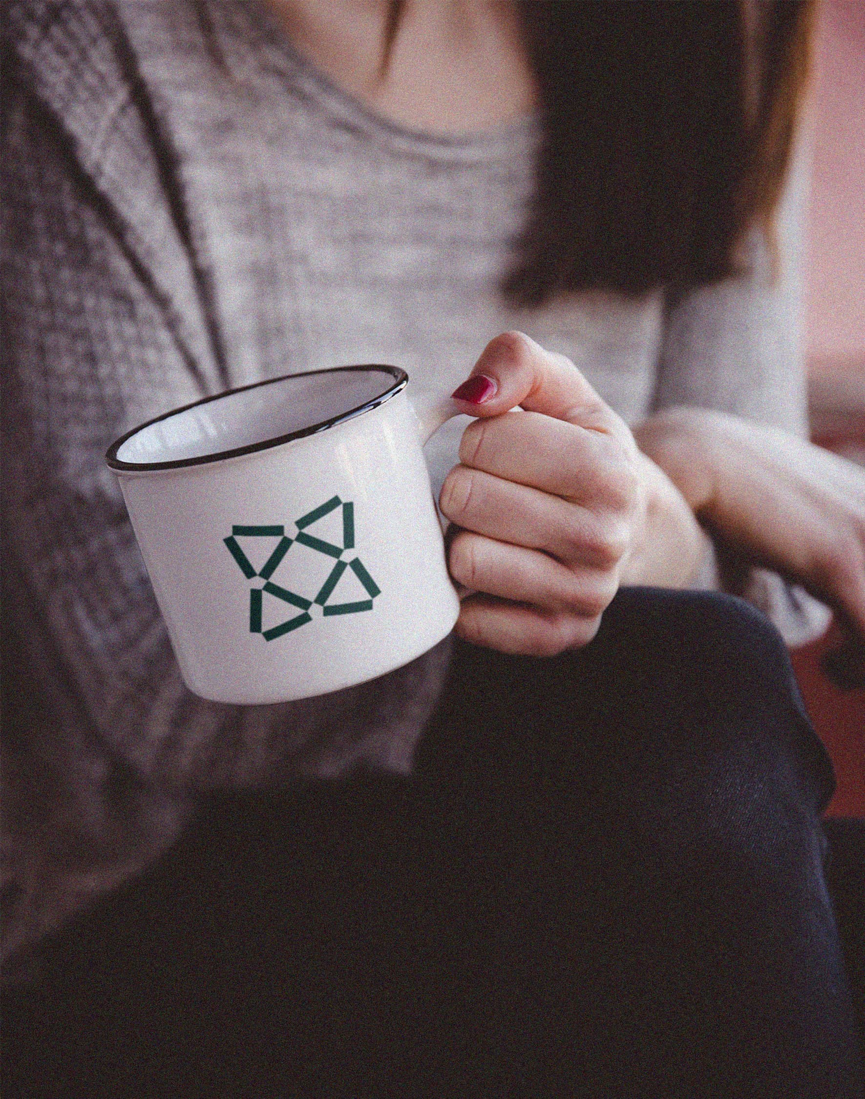 A white camping mug with the Wolf Pack emblem.