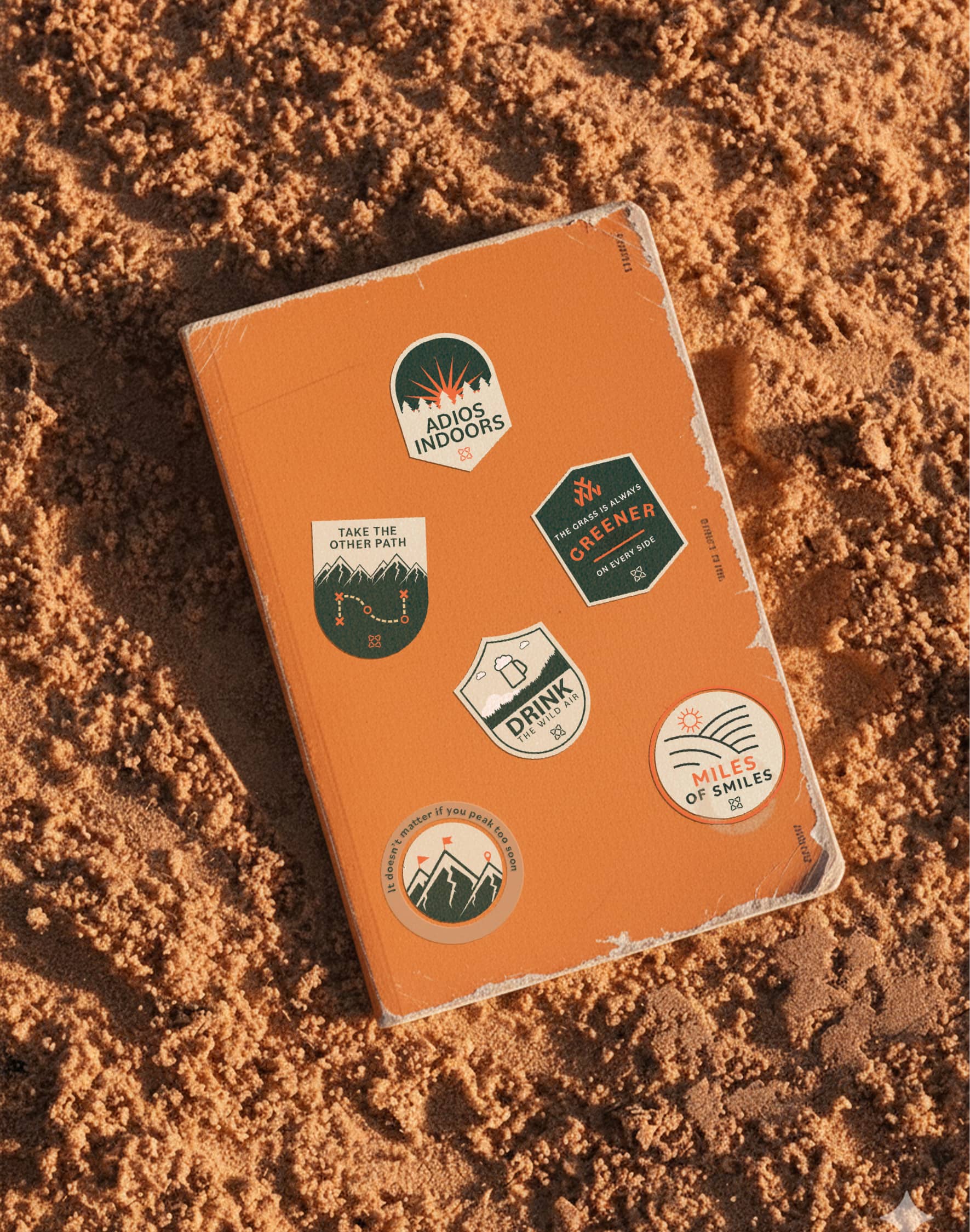 Wolf Pack outdoor-themed stickers on an orange notebook.