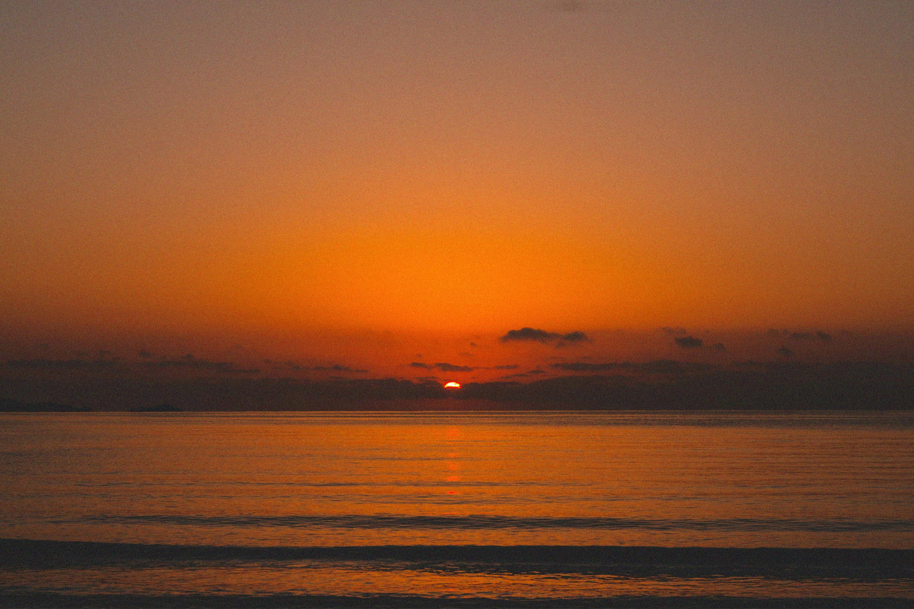 An orange sunset over the sea.